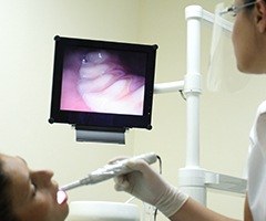 Dentist and patient looking at intraoral photos