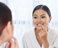 examining teeth in mirror