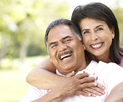 A couple smiling and hugging each other