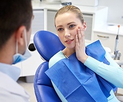 Woman holding jaw in pain