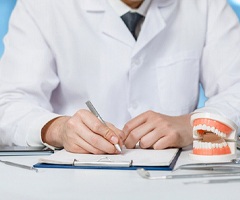 Writing treatment plan to help patient recover from dental emergency
