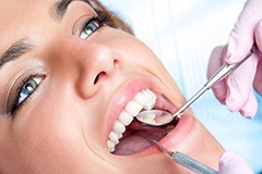 Closeup of woman receiving dental exam