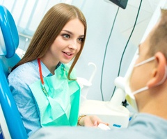 A woman speaking with a dentist.