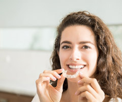 woman holding Invisalign