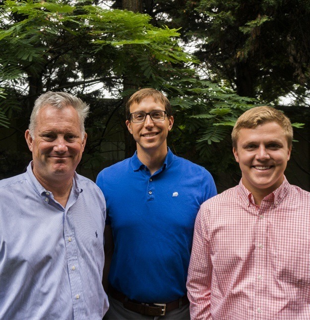 Three doctors smiling togehter