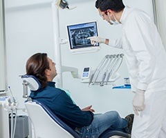 Dentist and patient looking at dental x-rays