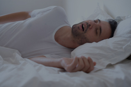 man snoring in bed