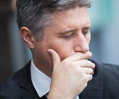 man covering his mouth