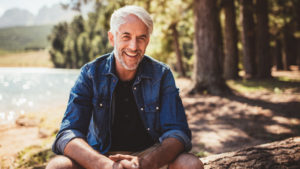 older man smiling outdoors