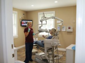 A dentist speaking with a patient,.