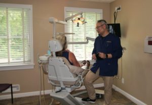 A dentist speaking with a patient.