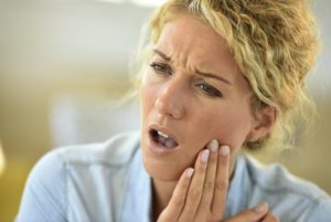 Woman needing to see emergency dentist in Charlottesville