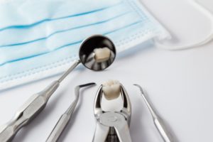 Closeup of tools and tooth after tooth extraction in Charlottesville